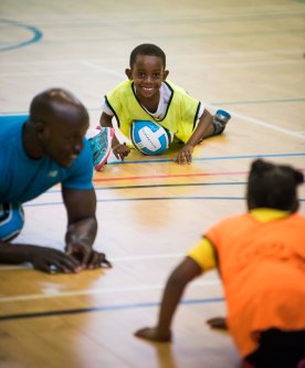 Children and volunteer doing exercises on the floor