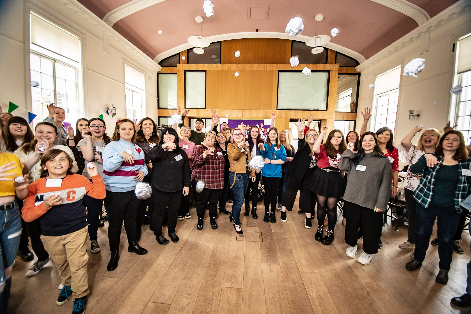 Young people at The Listening Fund launch throwing balls of paper