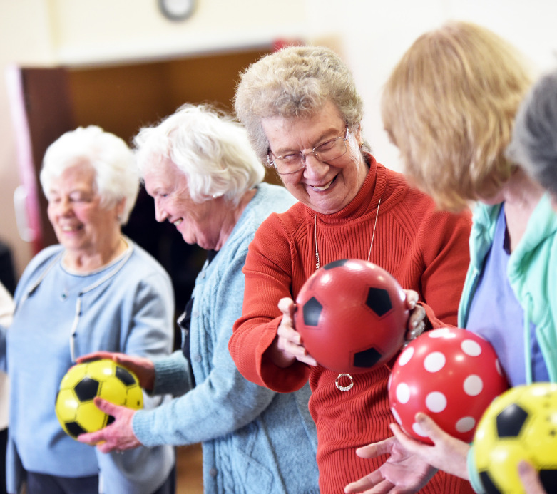 Older ladies passing balls to each other