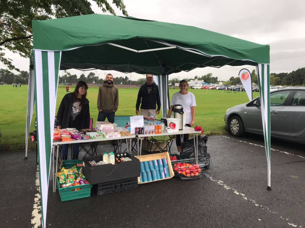 The EATS Rosyth team standing by their pop up food stall selling surplus food, tea and coffee and cakes for donations.
