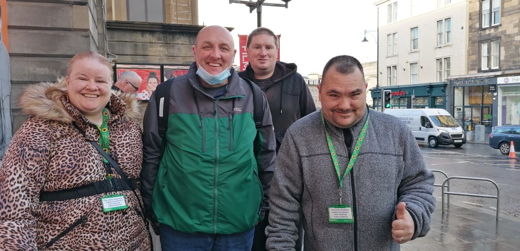 The group pictured outside the Filmhouse, smiling as they meet in person for the first time since before the pandemic.